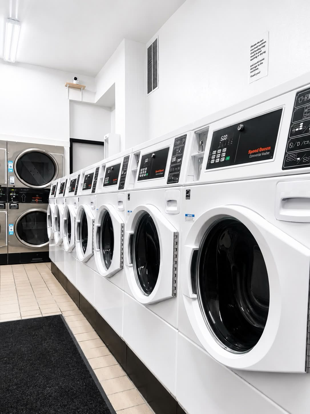 Row of white washers inside SF City Laundromat