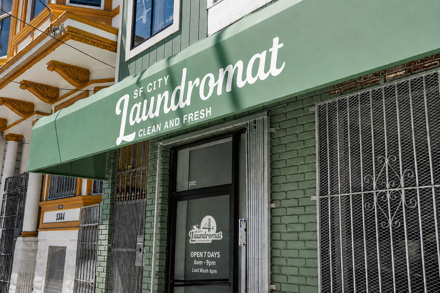 SF City Laundromat storefront with green awning