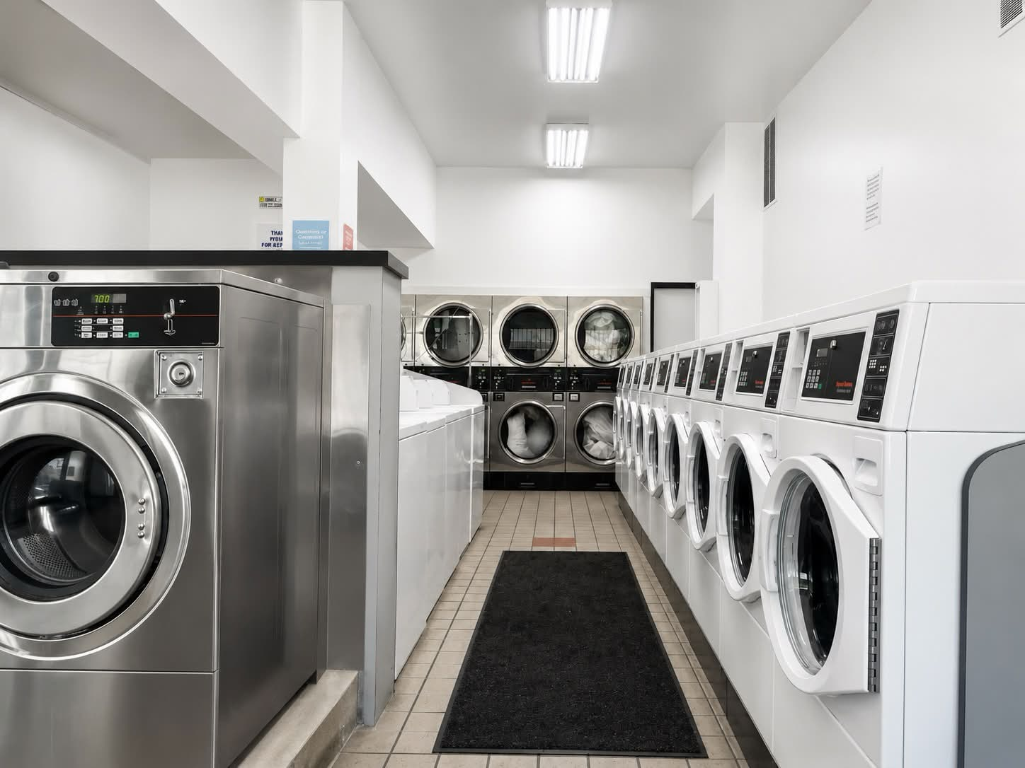 Interior view of SF City Laundromat with washer and dryer rows